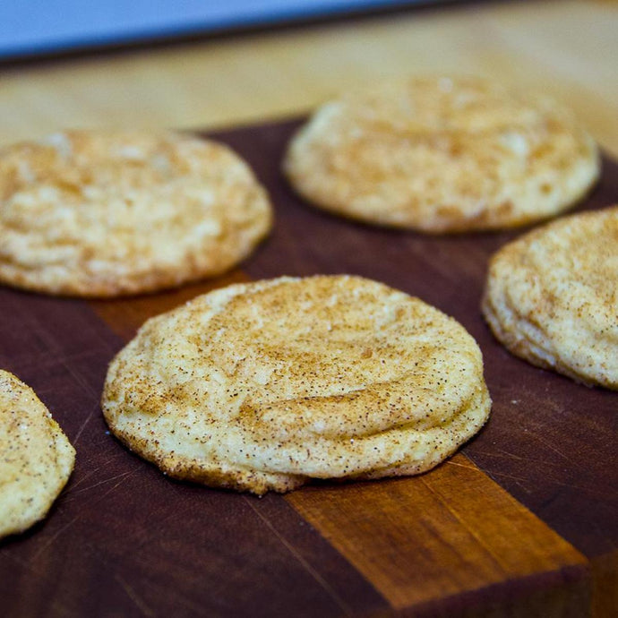 snickerdoodle cookie sitting on a brown cutting board
