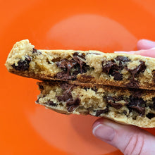 Load image into Gallery viewer, a chocolate chip cookie that has been split in half to see the inside
